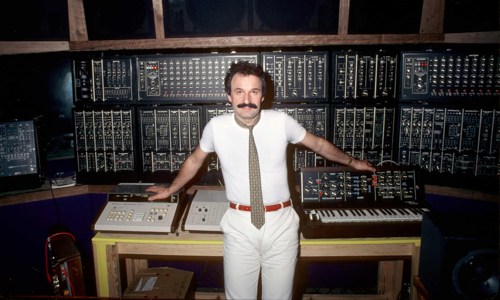 Giorgio Moroder in his studio surrounded by synthesizers and electronic music equipment